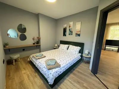 a bedroom with a large bed with a white bedspread at La Terrassa 7 in Burgas City