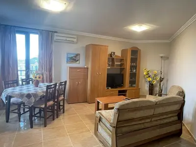 a living room with a table and a couch at Quiet 1-Bed Flat in Antonia Complex by Flat Mаnager in Sveti Vlas