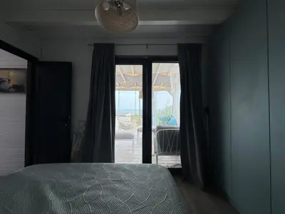 a bedroom with a bed and a door to a patio at Camping Gardenia - Bungalow SeaBed in Lozenets