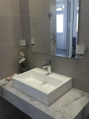 a bathroom with a white sink and a mirror at Kaleya House in Chernomorets