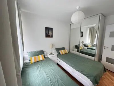 a bedroom with two beds and a large mirror at Apartament A 2BD in Burgas City