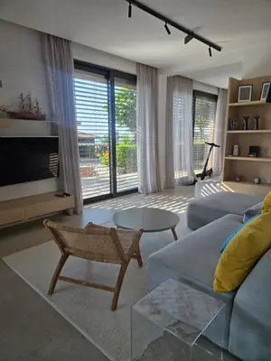 a living room with a couch and a table at Sozopolis Sunset Apartment with sea view in Sozopol