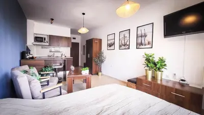 a bedroom with a bed and a living room at Studio Comfort Blue in Primorsko
