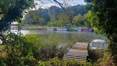 a boat is docked next to a dock on a river at Studio Comfort Blue in Primorsko