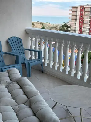 a balcony with two chairs and a table and a view of the ocean at Miramar Palace 615 in Sunny Beach