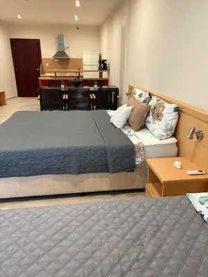 a bedroom with a bed and a couch and a piano at Miramar Palace 615 in Sunny Beach