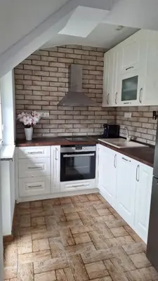 a kitchen with white cabinets and a stove top oven at Апартамент ReLax Китен in Kiten