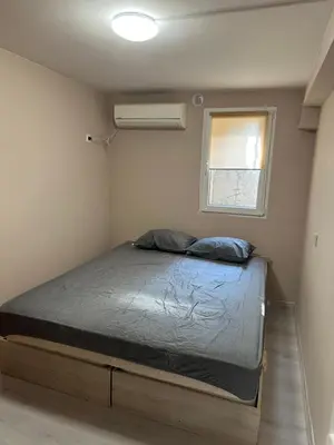 a bed in a small room with a window at Rumen Apartment in Nesebar