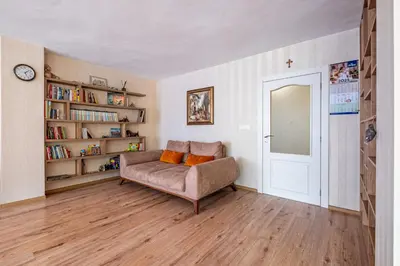 a living room with a couch and a book shelf at Top Location 3 Bedroom Apartment Next to the Beach in Varna City