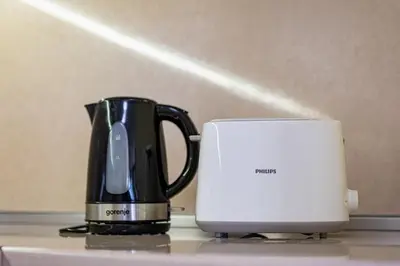 a coffee pot and a toaster on a counter at Top Location 3 Bedroom Apartment Next to the Beach in Varna City