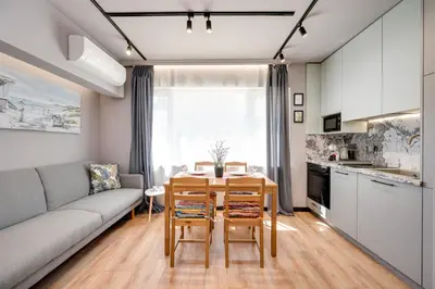 a living room with a couch and a table and chairs at Top Central Flats with Style in Varna City