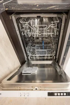 a dishwasher with a rack of dishes in it at Marea 1 in Pomorie