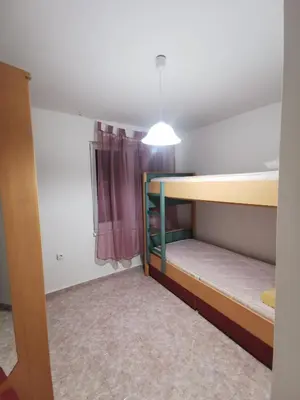 a room with two bunk beds and a window at Мезонет в Гръцката Махала in Varna City