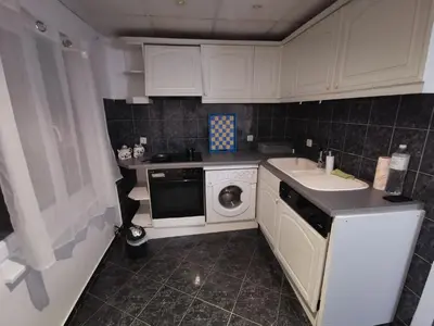 a small kitchen with a sink and a dishwasher at Мезонет в Гръцката Махала in Varna City
