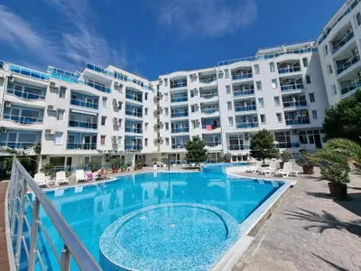 a large apartment building with a large swimming pool at Odisei Large Studio in Nesebar