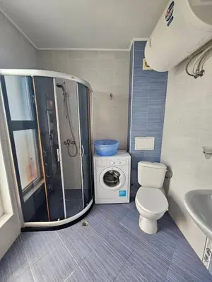 a bathroom with a shower and a toilet and a sink at Odisei Large Studio in Nesebar