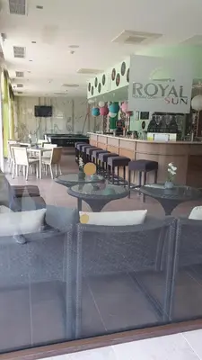 a restaurant with tables and chairs in a room at Royal Sun Apartment in Sunny Beach
