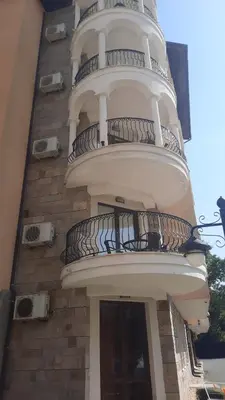 a building with a spiral staircase on the side of it at Royal Sun Apartment in Sunny Beach