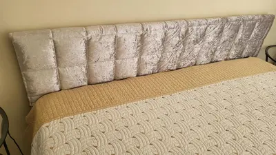 a close up of a bed with a head board at Делукс апартамент -Тюркоазен релакс in Pomorie