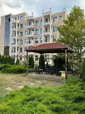 a gazebo in a park in front of a building at Sveti Vlas, Rodopi Bay Residence in Sveti Vlas