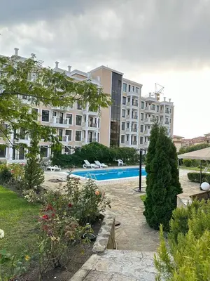 a large building with a swimming pool in a yard at Sveti Vlas, Rodopi Bay Residence in Sveti Vlas