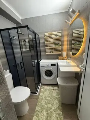 a bathroom with a shower sink and a washing machine at Sveti Vlas, Rodopi Bay Residence in Sveti Vlas