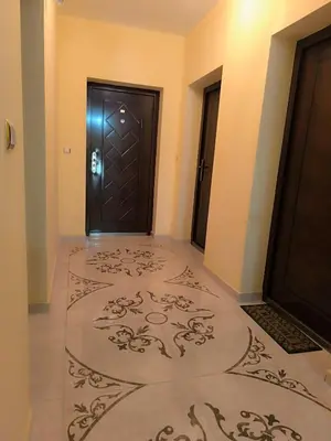 a hallway with a door with a rug in front of it at Golden Hermes, Studio z basenem in Sunny Beach