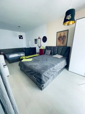 a bedroom with a large bed and a couch at Rose Garden Apartment 10 in Sunny Beach