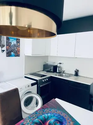 a kitchen with a washing machine and a sink at Rose Garden Apartment 10 in Sunny Beach