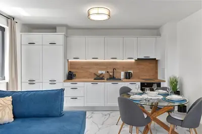 a living room with a blue couch and a table at SEA SHELL Apartment in Sozopol