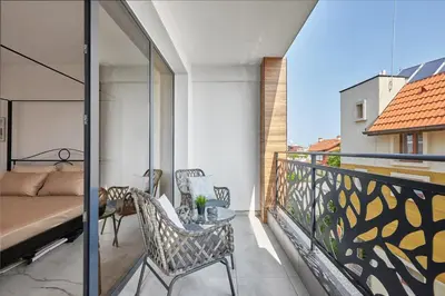 a balcony with a bed and a table and chairs at SEA SHELL Apartment in Sozopol