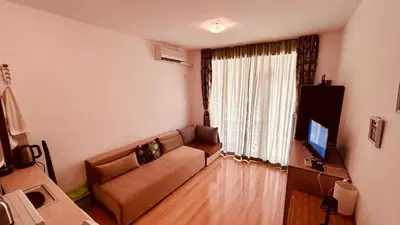 a living room with a couch and a window at Sunny Day 6 Studio 11 in Sunny Beach