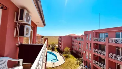 an apartment balcony with a swimming pool and buildings at SUNNY DAY 6, Apartment 35 in Sunny Beach