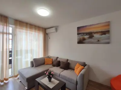 a living room with a couch and a table at Chocolate Apartment on Sunny Day 6 Complex in Tŭnkovo