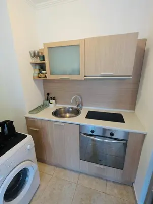 a small kitchen with a sink and a washing machine at VODENICATA 5B4 Apartment Sveti Vlas in Sveti Vlas