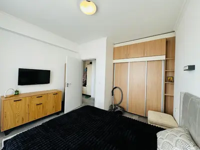 a bedroom with a bed and a tv on a wall at AQUA BLUE APARTMENTS 38 Penthouse Sunny Beach in Sunny Beach