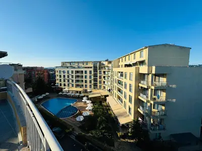 arial view of a building with a pool in front of it at AQUA BLUE APARTMENTS 38 Penthouse Sunny Beach in Sunny Beach