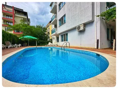 a large blue swimming pool next to a building at Top floor luxury apartment in Sunny Beach in Sunny Beach