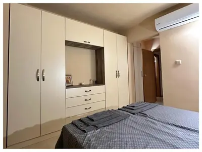 a bedroom with a bed and a mirror and cabinets at Top floor luxury apartment in Sunny Beach in Sunny Beach