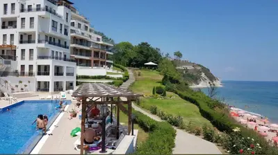 a hotel with a swimming pool next to a building at Byala Vista A-54 in Byala
