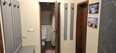 a bathroom with a toilet next to a door at Byala Vista A-54 in Byala