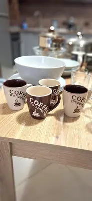 four coffee cups sitting on a wooden table at Byala Vista A-54 in Byala