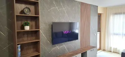 a living room with a tv on a wall at Byala Vista A-54 in Byala