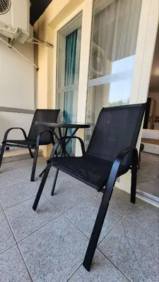 two black chairs and a table on a balcony at Hotel Solemar in Sunny Beach