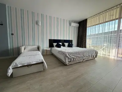 a bedroom with a bed and a large window at BW - Studio Grenada 316B in Sunny Beach