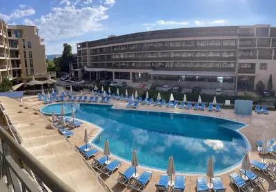 a large swimming pool with chairs and umbrellas at BW - Studio Grenada 316B in Sunny Beach