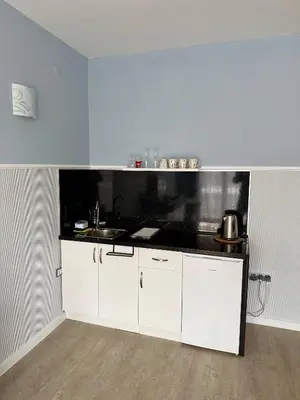 a kitchen with white cabinets and a black counter top at BW - Studio Grenada 316B in Sunny Beach