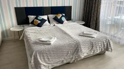 a bedroom with a large bed with a white comforter at BW - Studio Grenada 316B in Sunny Beach