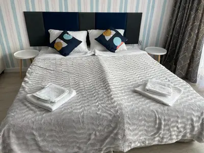 a white bed with two white towels and pillows on it at BW - Studio Grenada 316B in Sunny Beach