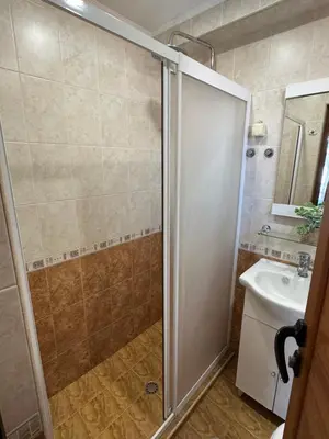 a bathroom with a shower and a sink at Guest House Amfora with a sea view in Sozopol